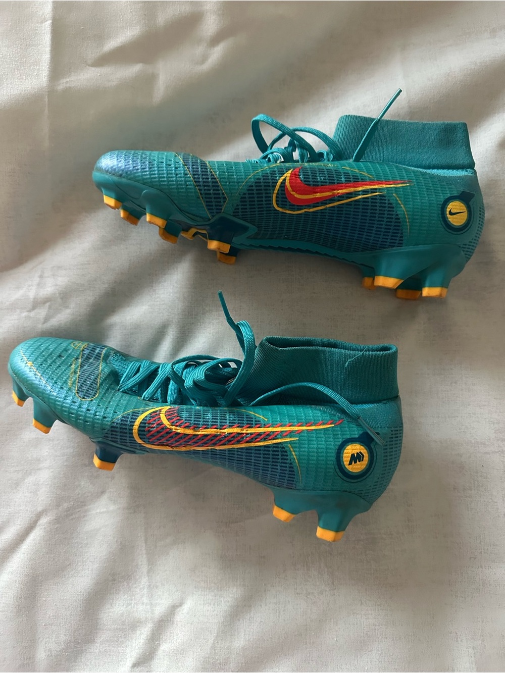 Nike Teal soccer cleats with Blue Stripe and Yellow Accents